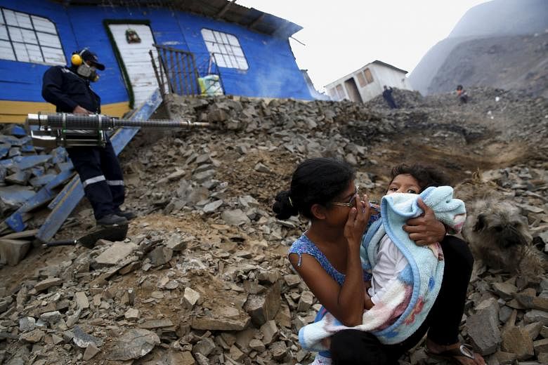 Residents waiting outside while their homes were fumigated as part of a campaign against the Zika virus and other mosquito-borne diseases on the outskirts of Lima in Peru on Monday. WHO chief Margaret Chan noted that it was "strongly suspected but no