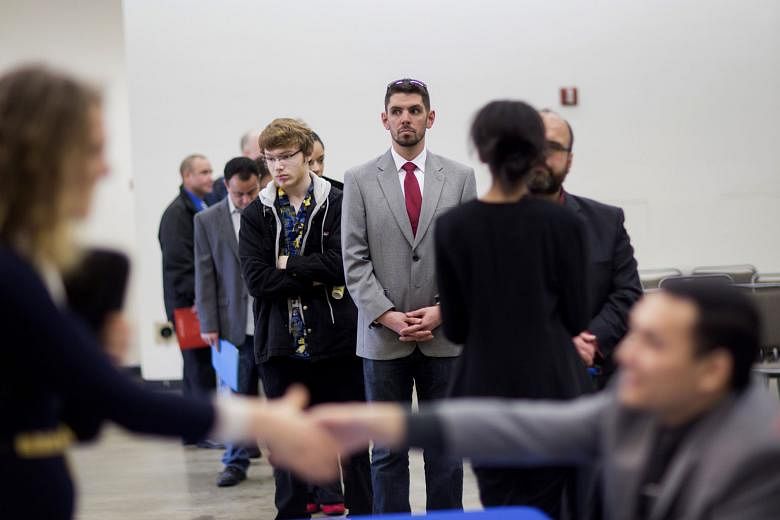 Job seekers at a career fair in Seattle, Washington, last week. The rise in the number of Americans filing for unemployment benefits last week signalled that the United States labour market may be losing some momentum.