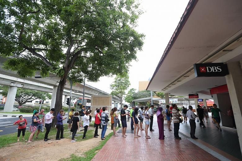 There were steady queues at banks and cash deposit machines islandwide yesterday, such as in Bedok Town Centre (above). Li Chun marks the start of spring in the Chinese calendar.