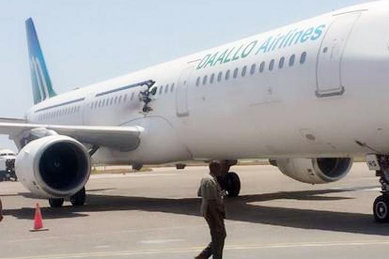 The Daallo Airlines plane (far left) made an emergency landing on Tuesday in the Somali capital of Mogadishu after a blast tore a 1m-wide hole (left) in the fuselage of the plane. Officials say one passenger was killed - the 55-year-old man was belie