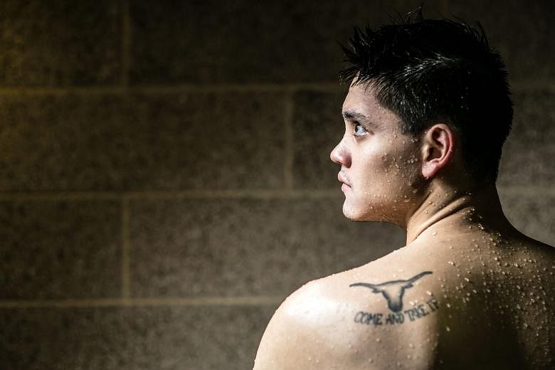Olympian Joseph Schooling sporting a tattoo of a Longhorn with the words "Come and take it" beneath the symbol. The phrase is what spurs his determination to go even faster.