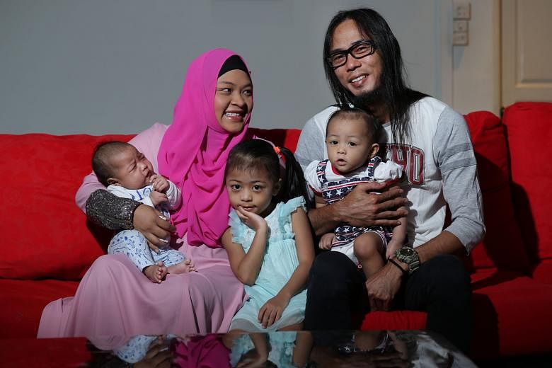 Madam Lydiawati Ibrahim and her husband Mohd Ali Isnin with their children Mohammad Rifly Asyraaf, two months old, A'lya Nayli Shazya, five, and A'lya Aamily Delisha, one. The two SG50 babies were both born at Gleneagles Hospital last year. Madam Lyd