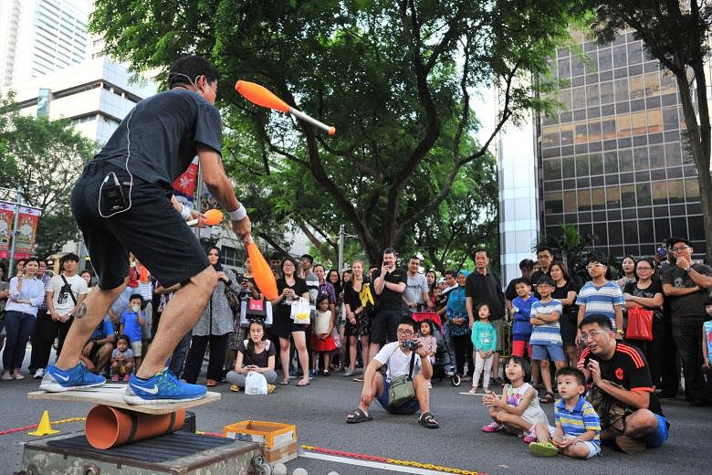 Busker Wee Toon Hee, 54, entertaining the crowd during yesterday's Pedestrian Night. The event sees a 660m stretch of Orchard Road closed to traffic on the first Saturday of every month. After last night, it is in hiatus until the organisers and the 