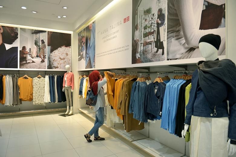 Teacher Norjanna Mohd Daud, 33, shopping in the "modest wear" section of the Uniqlo outlet at 313@Somerset. The market potential here for such apparel is large, with 15 per cent of the resident population being Muslims.