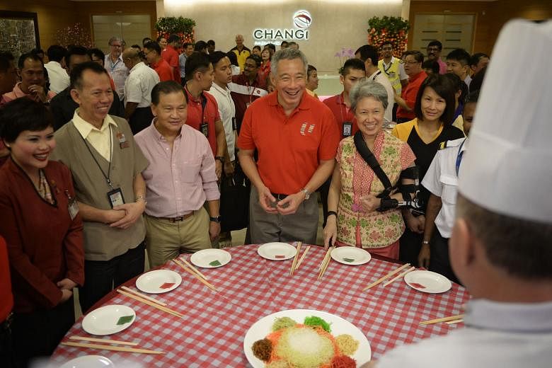 PM Lee and Mrs Lee, who had her left arm in a sling, with union leaders and airport staff at a traditional lo hei event at Changi Airport on the first day of Chinese New Year. Mrs Lee had injured herself while she was on one of her hoverboards three 
