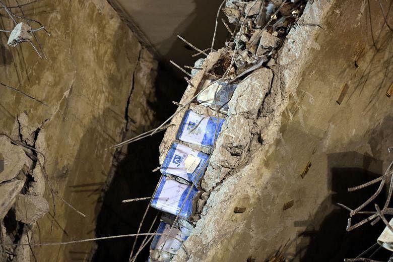 Metal cans seen between layers of concrete at the collapsed Wei-guan complex in Tainan. At least 39 people were killed when the building toppled early last Saturday.