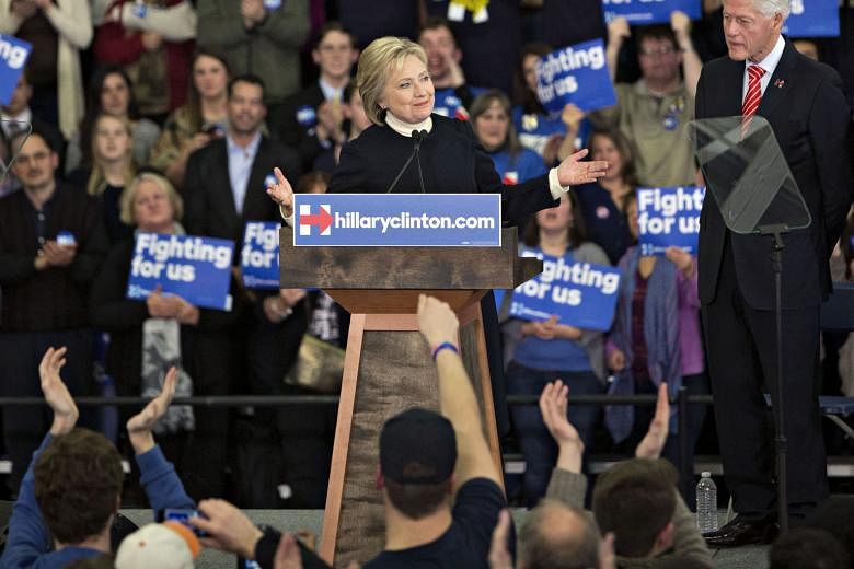 Mrs Hillary Clinton speaking at a primary night event in Manchester, New Hampshire, on Monday with her husband Bill Clinton (right) beside her. The success of the Clinton campaign is dependent on her beating rival Bernie Sanders among women and attra