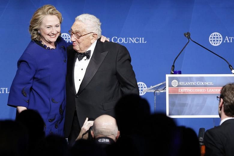 Clinton supporters are afraid that her friendship with Mr Kissinger - seen here presenting Mrs Clinton with a Distinguished Leadership Award from the Atlantic Council in Washington in 2013 - is hurting her presidential chances.