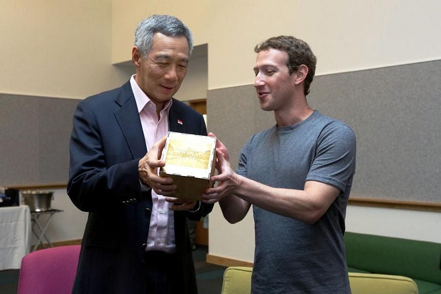 Mr Lee met Apple chief Tim Cook (left) and Facebook chief Mark Zuckerberg on his second day in Silicon Valley. In recognition of Mr Lee's ability to code, Mr Zuckerberg presented him with a cube which included lines from a computer program the PM wro