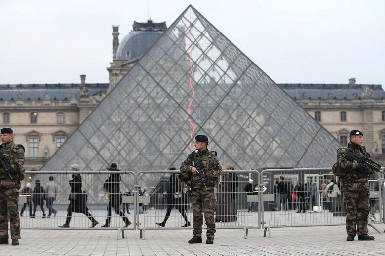 Attendance in Paris museums such as The Louvre (left) has dropped since the Islamist attacks last year.
