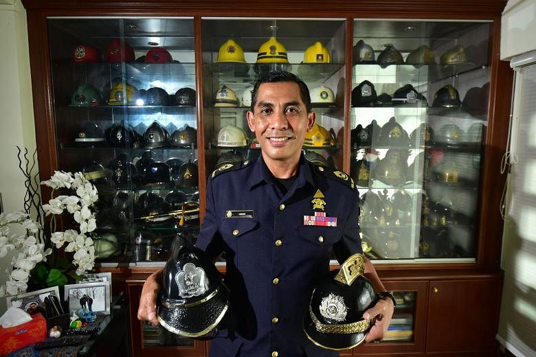 SWO Junaidi with two of his most prized items - a vintage Greek fire brigade helmet (right) and a leather helmet from the now-defunct Singapore Fire Brigade. The 55-year-old says the most meaningful part of his hobby is his cultural exchange with for