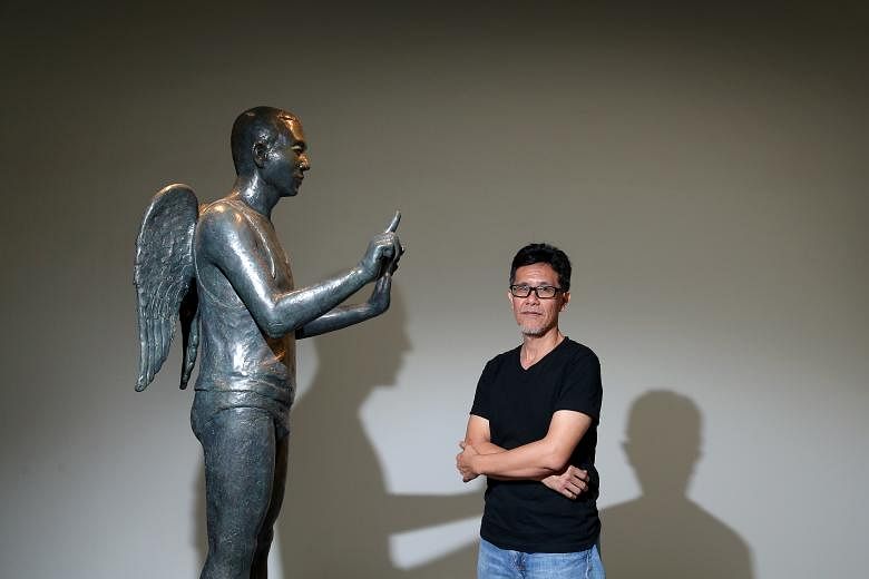 Lim Soo Ngee with a bronze sculpture in his solo show.