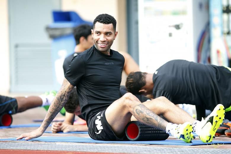 Jermaine Pennant (left) warming up before Tampines' training at Jurong West Stadium yesterday. If the Englishman does play against Faritz Hameed's Geylang, the former LionsXII player will be one of those tasked with muzzling the former Arsenal and Li