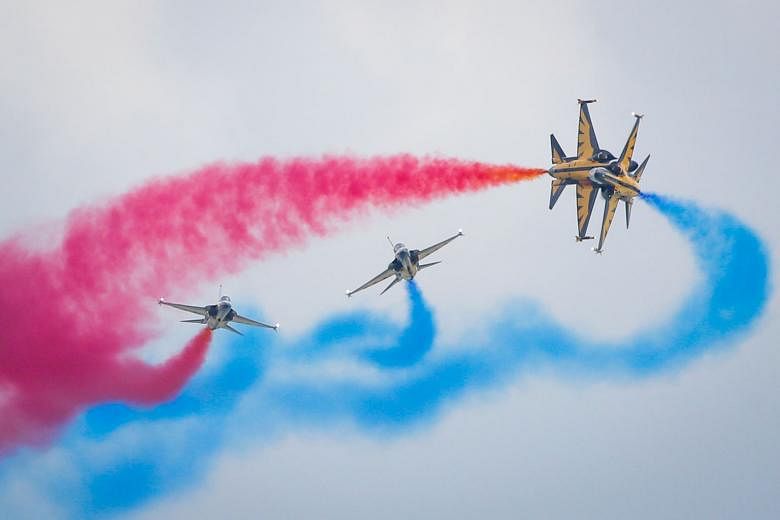 Members of the Republic of Korea Air Force's Black Eagles flying South Korean-made T-50 jets as they executed death-defying high-speed manoeuvres off the Changi coast. The renowned aerobatics team is in town for the Singapore Airshow 2016. SEE TOP OF