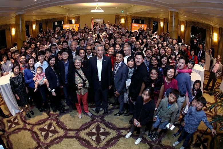 PM Lee and his wife, Mrs Lee, with Singaporeans in the US at a Chinese New Year event in San Francisco. The guests included students, working professionals and families.