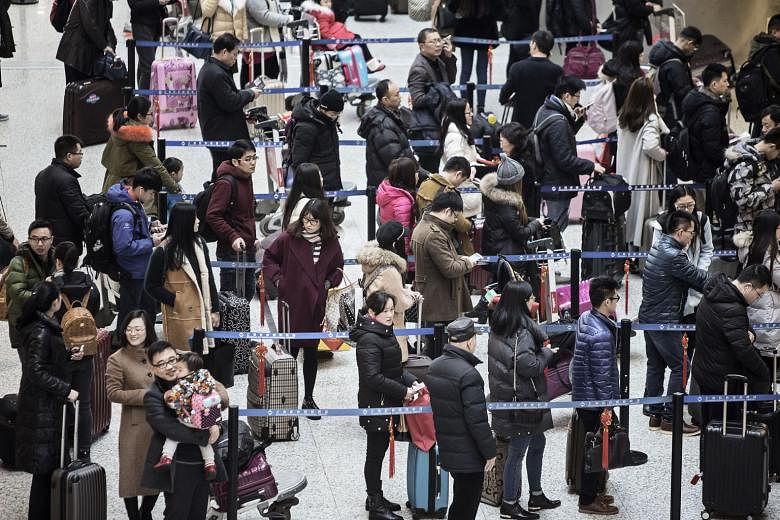 Travellers waiting to check in at Shanghai Hongqiao International Airport. To work around the country's cash controls, people in China are asking friends or family members to carry or transfer out US$50,000 each.