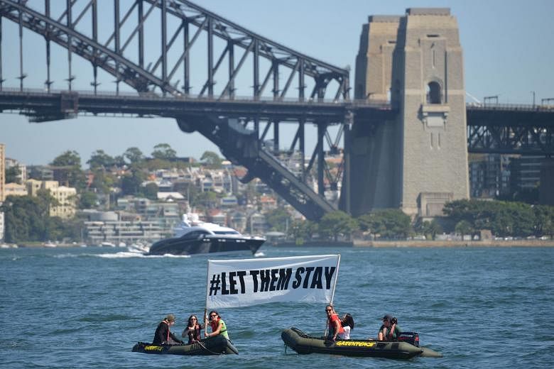 Activists campaigning in front of the Harbour Bridge in Sydney yesterday to stop the return of 267 refugees to the Nauru detention facility. The asylum seekers had been brought to Australia for medical treatment.
