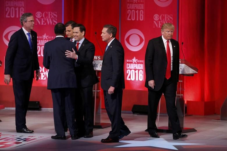 Mr Trump (far right) walking off the stage as his rivals (from left) Mr Bush, Dr Carson, Mr Cruz, Mr Rubio and Mr Kasich gather at the conclusion of the debate in Greenville, South Carolina, on Saturday. The showdown featured some of the Republican p