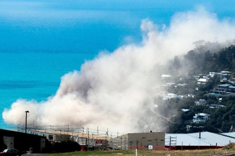 Dust and debris rising above houses after a cliff collapsed during an earthquake in the Whitewash Head area, above Scarborough Beach in the Christchurch suburb of Sumner. The mayor of Christchuch said the new quake was a big shock to the city. In 201