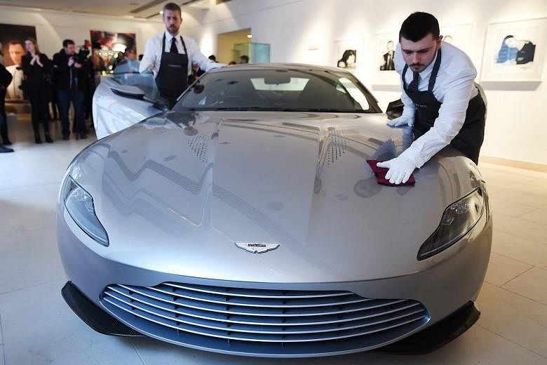 Christie's auction house staff polishing an Aston Martin DB10 during the James Bond Spectre auction press preview at Christie's in London, Britain, yesterday. The DB10 is expected to fetch €1.2 million (S$1.9 million) to €1.7 million at an online