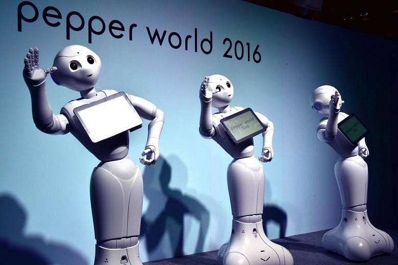 "Pepper" humanoid robots dancing to attract customers at an exhibition in Tokyo last month. Professor Bart Selman of Cornell University said computers are "starting to 'hear' and 'see' as humans do". Business giants such as Google, Facebook, IBM, Mic