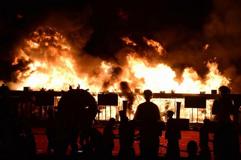 Fanned by high winds, the fire quickly spread, licking the sides of a scaffolding rig and lighting up the night sky at a cultural event on Sunday. The inferno was believed to have been caused by an electrical short circuit and 14 fire engines and 10 