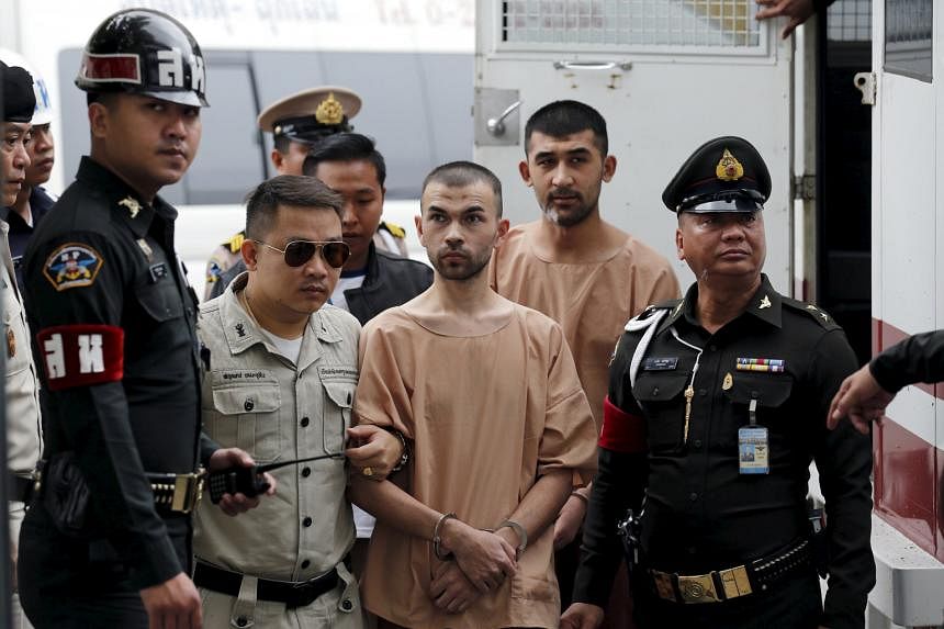 Bilal Mohammed (centre), also known as Adem Karadag, and Mieraili Yusufu are escorted by officers as they arrive at the military court in Bangkok. Mieraili is accused of delivering the bomb, while Bilal is suspected of placing a backpack containing t