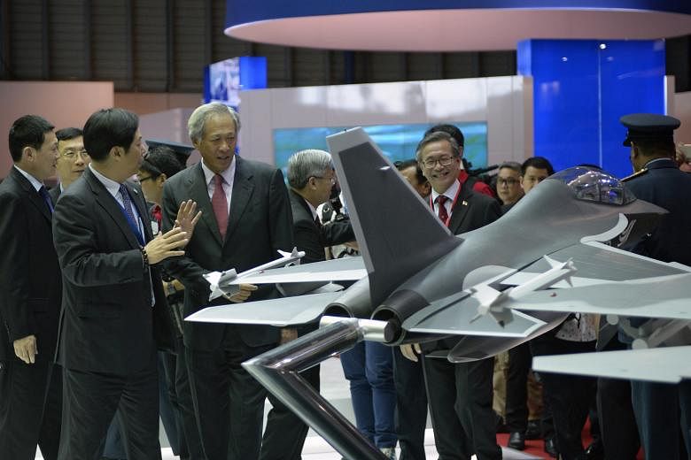 The deal was signed on the sidelines of the airshow, attended by Defence Minister Ng Eng Hen (fourth from left) - seen here at the Boeing booth yesterday.