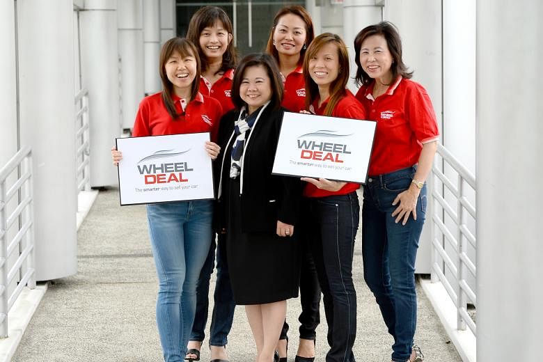 SPH Print Classified Call Centre senior advertisement sales director Florence Tan (in black) with the Wheel Deal team. Since its launch in November last year, the platform - which has about seven used car dealers in its network - has received over 3,
