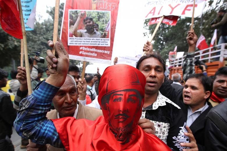 An activist wearing the mask of Indian revolutionary Bhagat Singh joining JNU students and their supporters in a protest march against the arrest of student leader Kanhaiya Kumar in New Delhi on Thursday. Top scholars, including American philosopher 