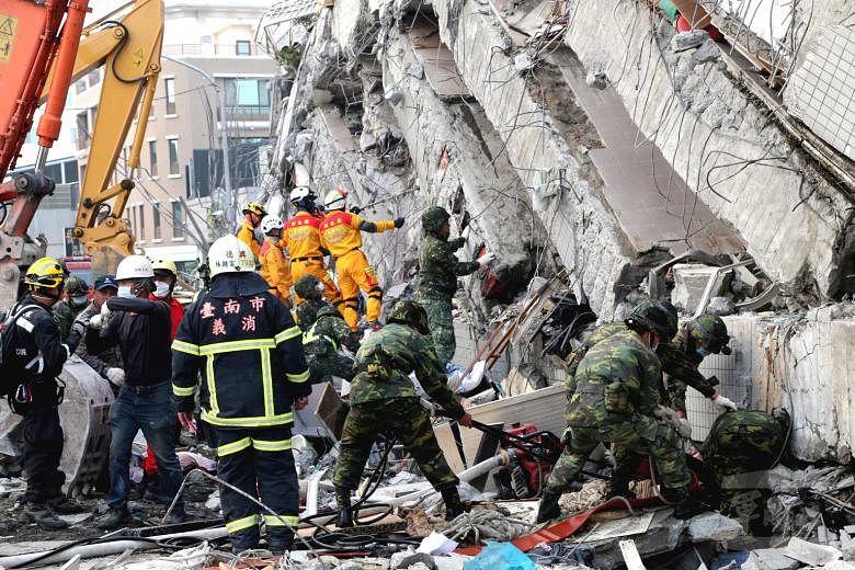 Emergency workers clearing away debris at the site of the collapsed Wei-guan Golden Dragon building last week. There is growing anger over allegations that the building was shoddily constructed.