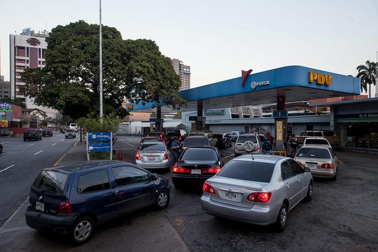 Queues formed at Venezuela's petrol stations before the 6,000 per cent price hike kicked in yesterday