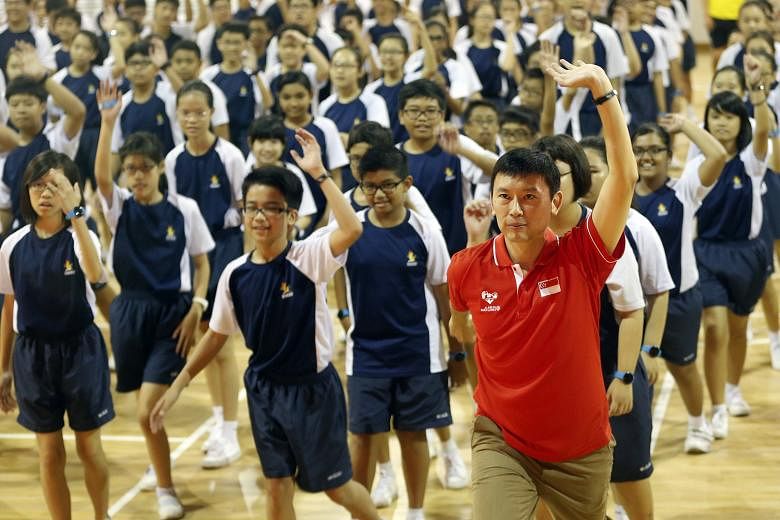 Minister of State for Health Chee Hong Tat (in red) joining students for an aerobics warm-up during the official launch of Rep With Steps held in Woodgrove Secondary School last Friday.