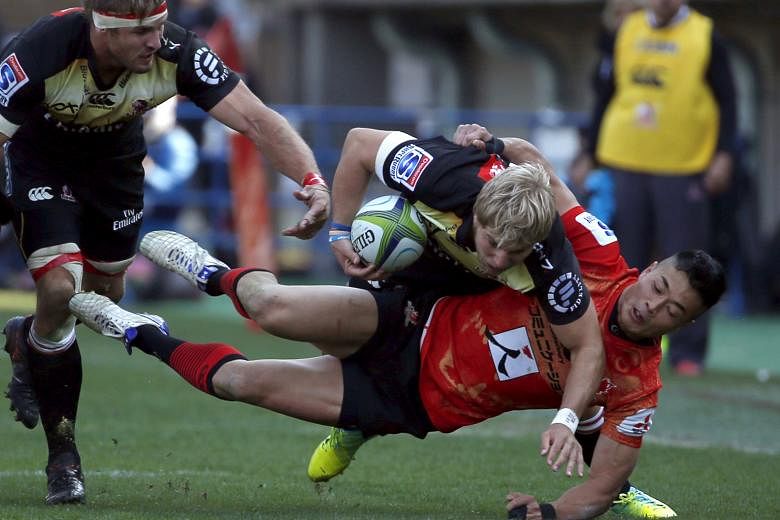 The Sunwolves' Akihito Yamada tackling the Lions' Jaco van der Walt yesterday in their Super Rugby opener in Tokyo. Despite a 26-13 defeat, the Japanese debutants acquitted themselves well.