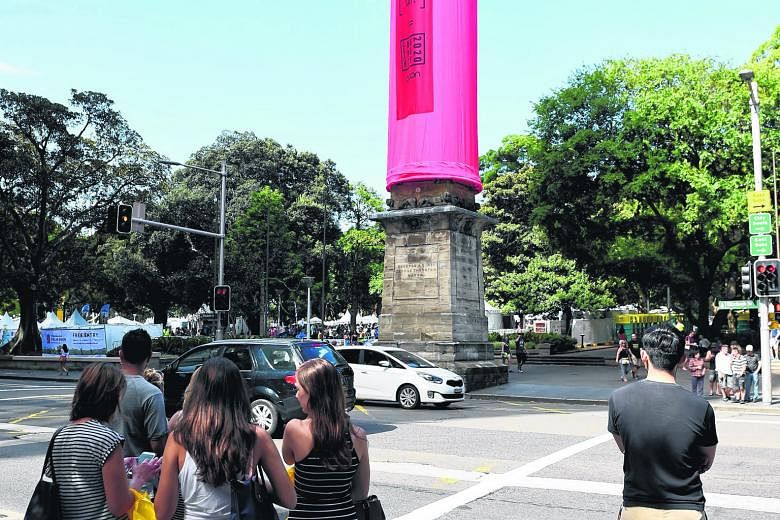 A giant pink condom covering the Hyde Park Obelisk catches the attention of pedestrians in Sydney. The 18m-long condom was slipped over the structure last Friday to promote safe sex in the lead-up to the Sydney Gay and Lesbian Mardi Gras slated for n