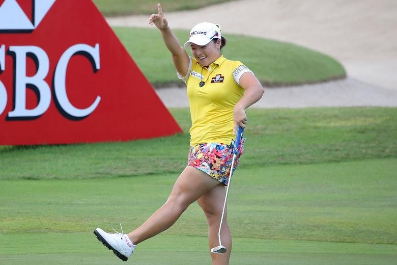 Jang Ha Na of South Korea does a victory dance after her final putt allowed her to emerge as winner of the HSBC Women's Champions by four shots at the Sentosa Golf Club.