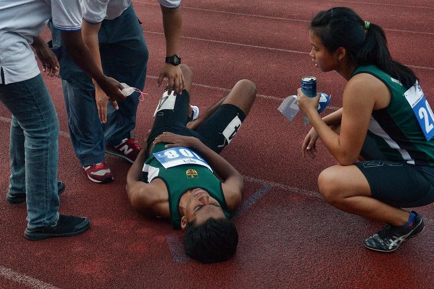 (Above) Athletes from the Singapore Sports School celebrating yesterday after being crowned overall champions of the SPH Schools Relay Championships for the sixth consecutive year. (Right) Prem Sathiamoorthy, from the triumphant Raffles Institution 4