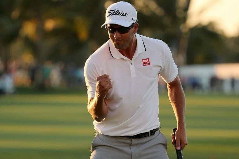Adam Scott reacting after putting in to win on the 18th hole during the final round of the WGC-Cadillac Championship.