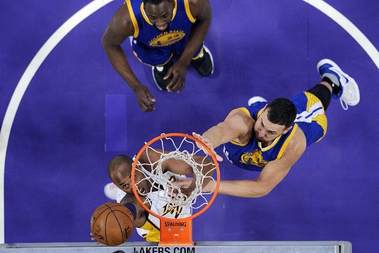 Kobe Bryant of the Los Angeles Lakers scoring against Andrew Bogut (right) and Draymond Green of the Golden State Warriors. The bottom-placed Lakers' 112-95 win over the table toppers is one of the biggest NBA upsets. The loss was just the Warriors' 