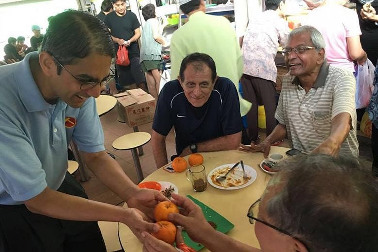 WP's Mr Leon Perera greeting residents at a hawker centre during Chinese New Year on Feb 6. The East Coast team says it started house visits much earlier this time than after GE2011.