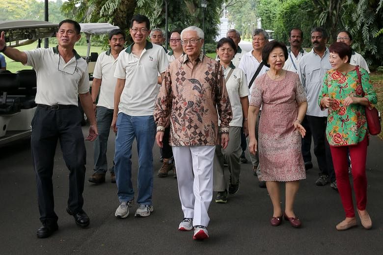 President Tan and Mrs Tan touring the Istana grounds, led by Mr Wong (far left), who shared in detail the late Mr Lee's involvement in various garden projects there.