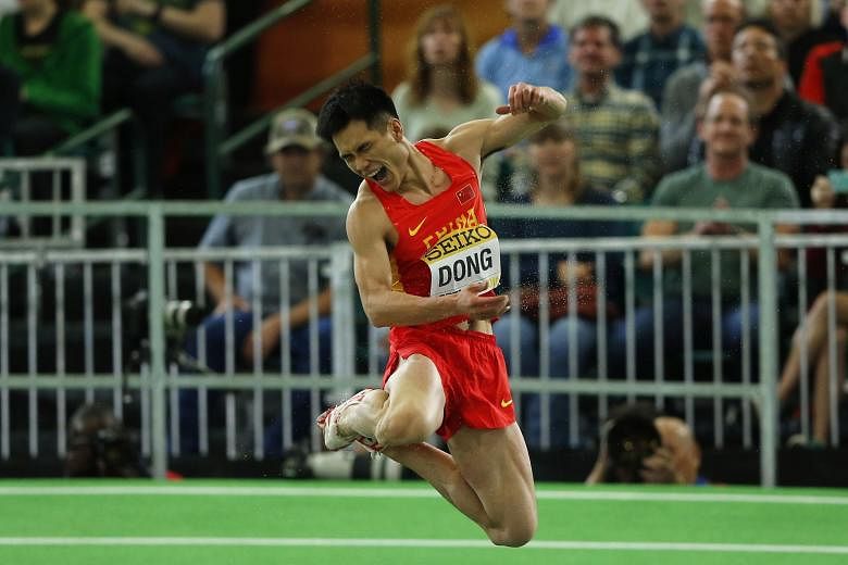 Dong Bin of China celebrates winning gold in the triple jump at the IAAF World Indoor Athletics Championships in Portland, Oregon on Saturday. He jumped 17.33m in the penultimate round to become only the third Chinese athlete to win a gold medal in t