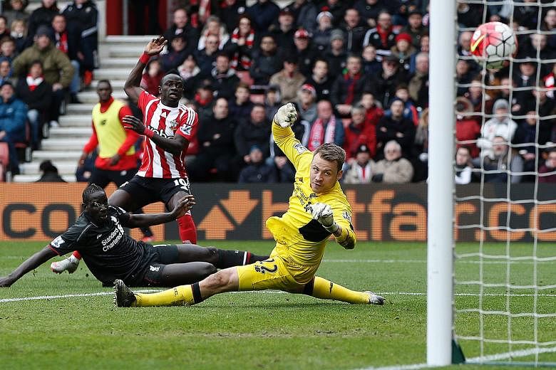 Southampton midfielder Sadio Mane raising his arm to celebrate after scoring their first goal past Liverpool goalkeeper Simon Mignolet. That sparked the Saints' rebound and they eventually claimed full points.