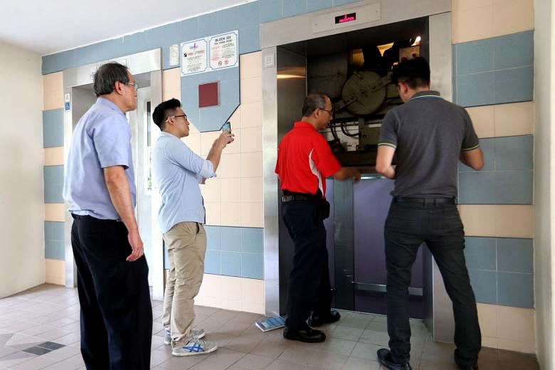Repairmen inspecting a lift at Block 322, Tah Ching Road, last October after a resident's hand was severed when the doors of the lift closed before her dog could enter, and while its leash was looped around her left wrist. As the lift moved up, her h