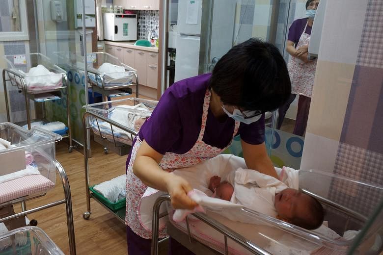 A nurse attending to a baby at the postnatal centre in Haenam General Hospital, in South Korea. The country's total fertility rate was 1.21 in 2014, similar to Singapore's 1.25 that year.