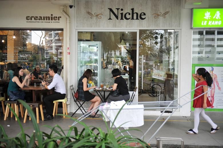Trendy cafes located near a busy market in Toa Payoh Lorong 1. More help can be given to businesses located in HDB estates to enliven them, MPs said.