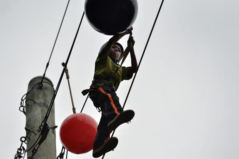 A Farrer Park Primary pupil taking part in adventure activities at the MOE Dairy Farm Outdoor Adventure Learning Centre. The new Sec 3 cohort camp, unlike the current two, will bring together students from various schools.