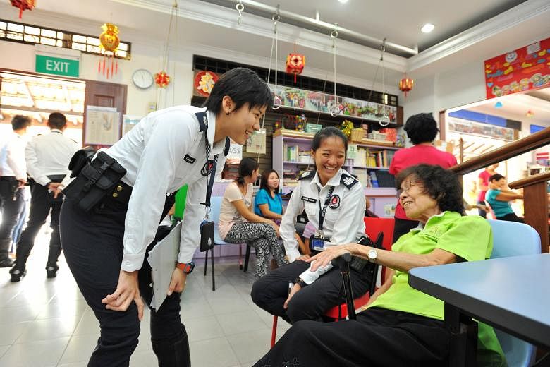 ASP Goh (left), 28, and Staff Sergeant Stephanie Cheung, 24, of TCOP - a new community policing unit - with Madam Ho Yin Heng, 76, at Xin Yuan Community Care centre at Block 205 Toa Payoh North. The unit had helped to establish a safer road crossing 
