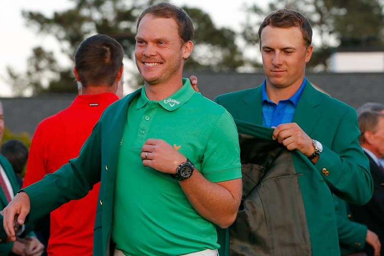 Jordan Spieth presenting Danny Willett with the green jacket after the Englishman won the final round of the Masters in only his second appearance at Augusta.