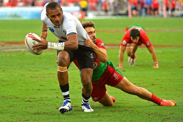 Fiji's Jasa Veremalua manages to shrug off the challenge of Portugal's Pedro Silverio to score a try in the pool match between Fiji and Portugal. The Fijians knocked 38 unanswered points past the Portuguese.
